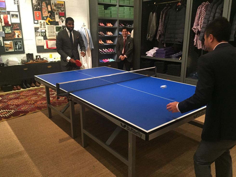 Playing ping-pong at Sid Mashburn + Ann Mashburn Houston Anniversary Party December 2014
