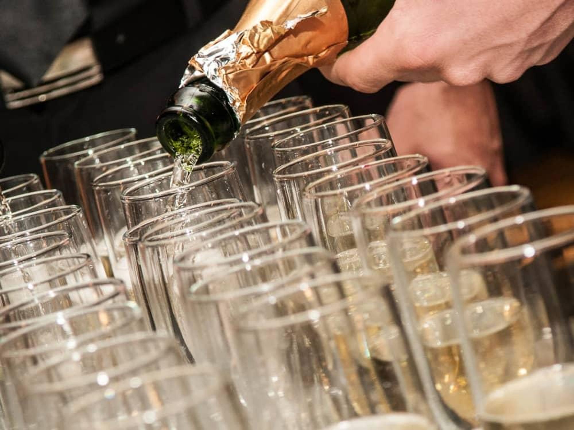 pouring champagne wine into glasses