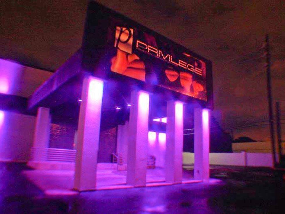 Privilege Club Houston strip club exterior night with neon lights