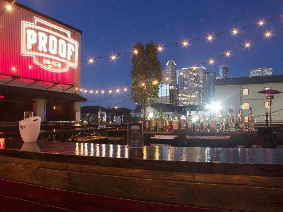 Proof Bar + Patio Houston bar counter skyline night