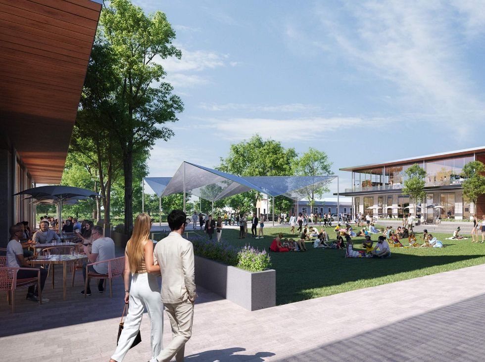 Residents gather on a lawn in a new housing development.