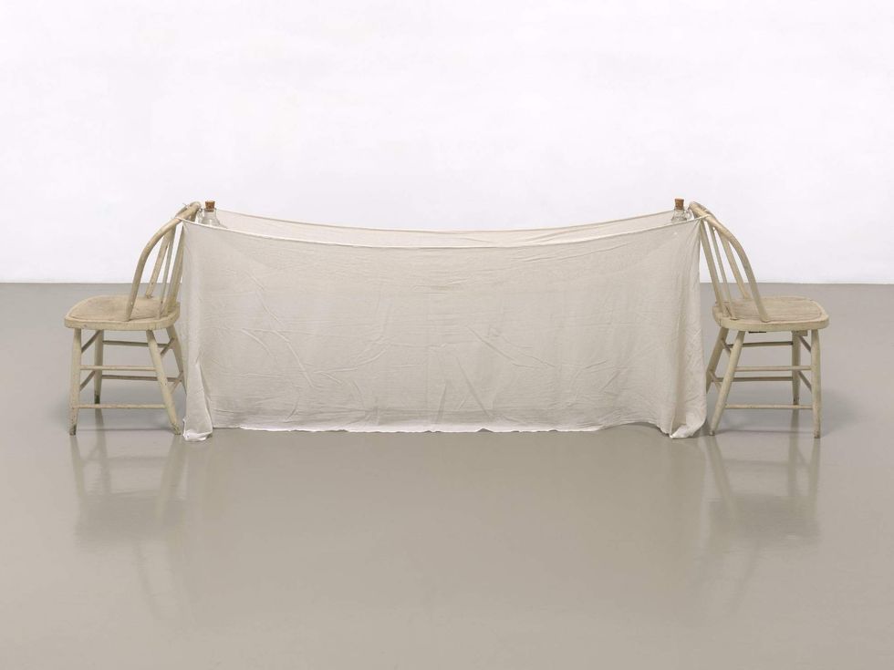 Robert Rauschenberg, Sant\u2019Agnese (Venetian), 1973. Mosquito net, wood chairs, shoelaces, and corked glass jugs, 32 1/4 \u00d7 105 3/4 \u00d7 22 1/8 in. (81.9 \u00d7 268.6 \u00d7 56.2 cm). Robert Rauschenberg Foundation. \u00a9 Robert Rauschenberg Foundation.