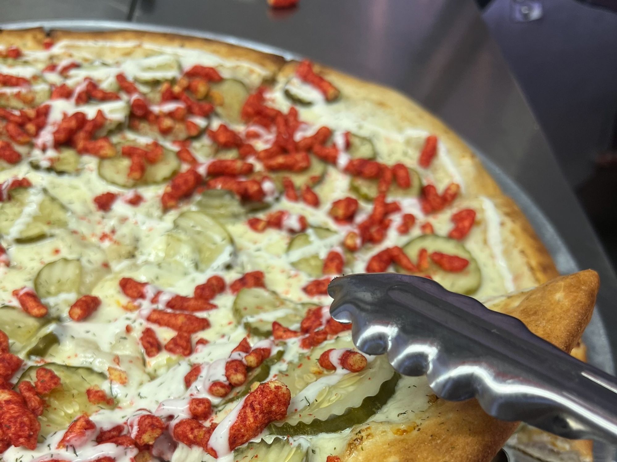 Rodeo Carnival hot cheetos and cheese pickle pizza