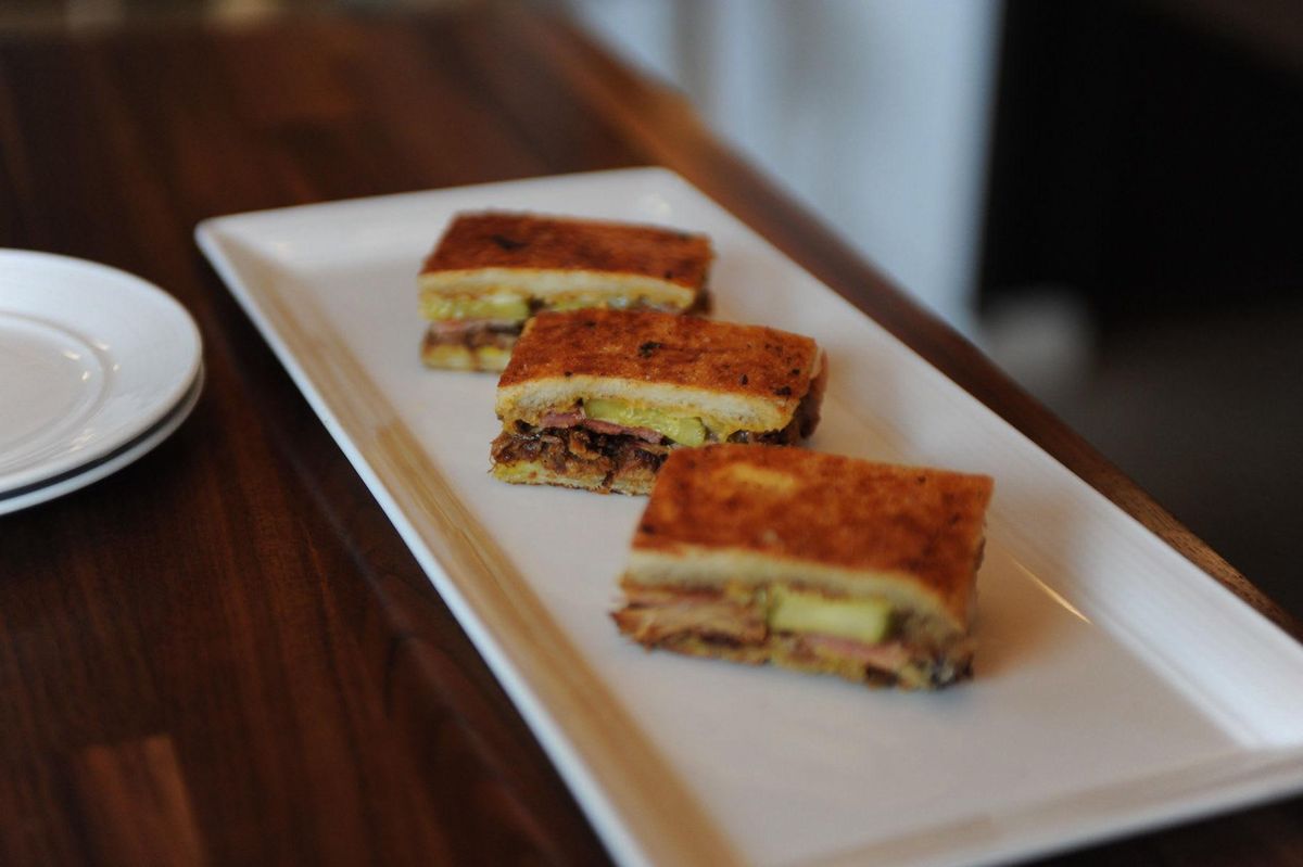 Cuban sandwich pulled pork, sliced ham, house made pickles, yellow