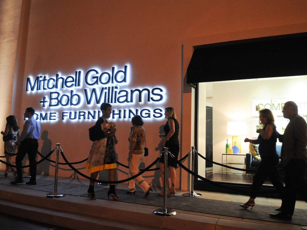 store exterior at night with people at the Mitchell Gold + Bob Williams Houston grand opening celebration