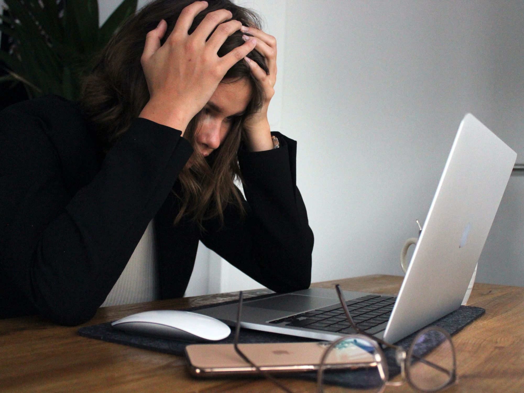 Stressed out woman looking at her laptop