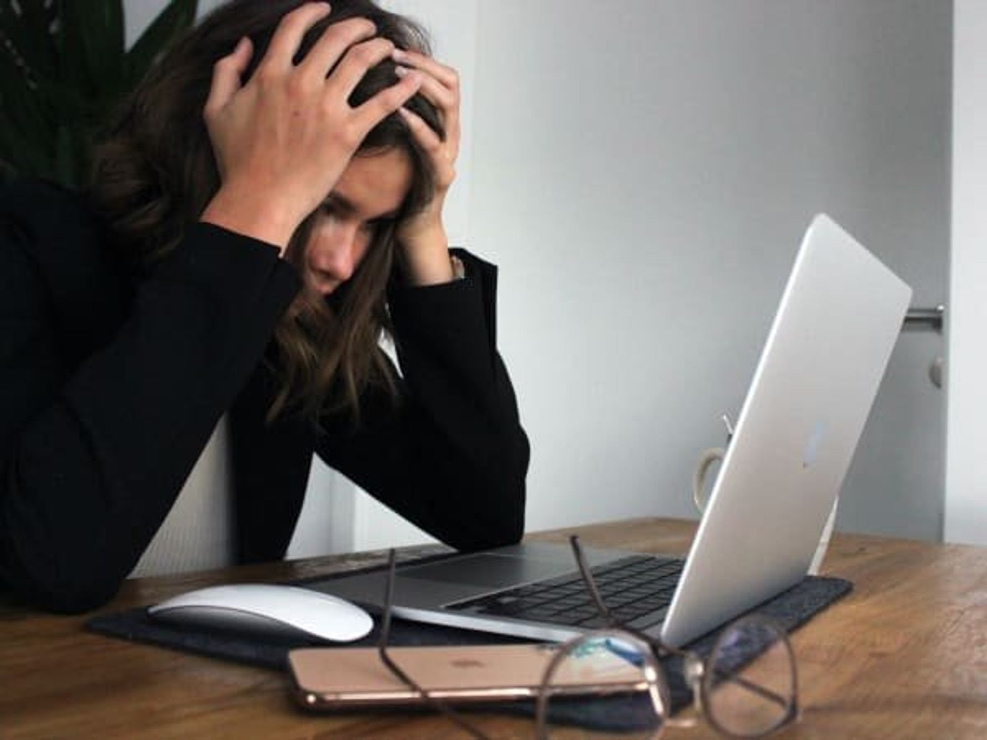 Stressed out woman looking at her laptop