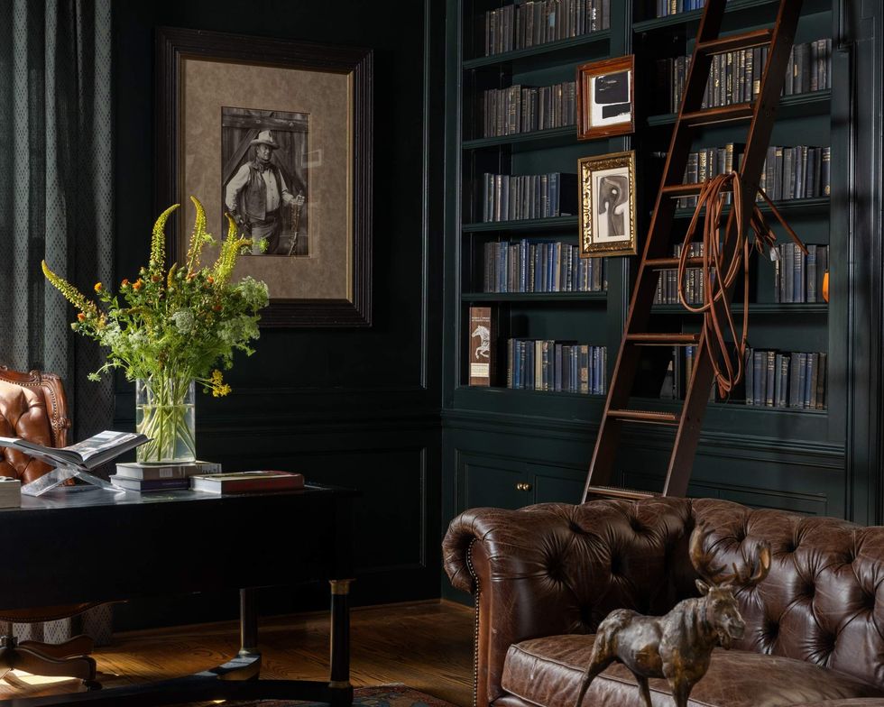 Study of 1069 Kirby Drive, with a book ladder and leather sofa