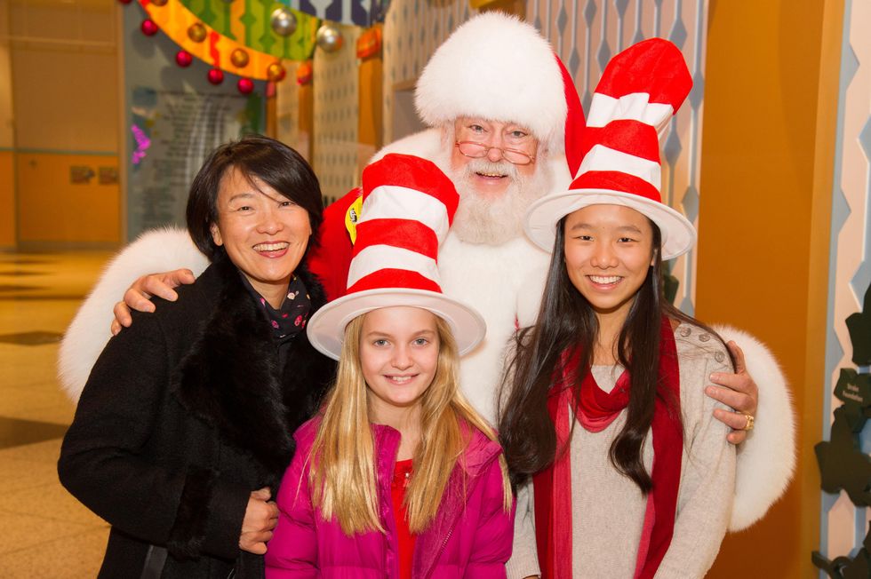Susan Jhin and children with Santa at Children's Museum Grinch party
