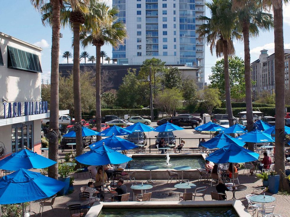 Taco Milagro Houston restaurant patio palm trees diner outside