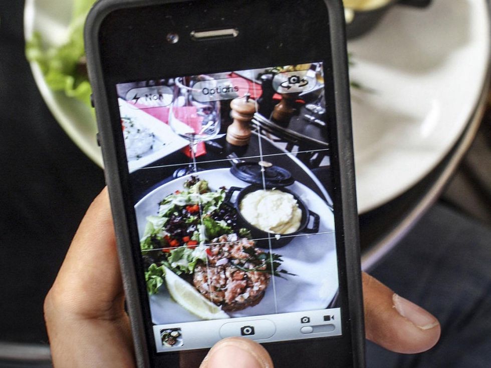 taking a photo of food with a cell phone