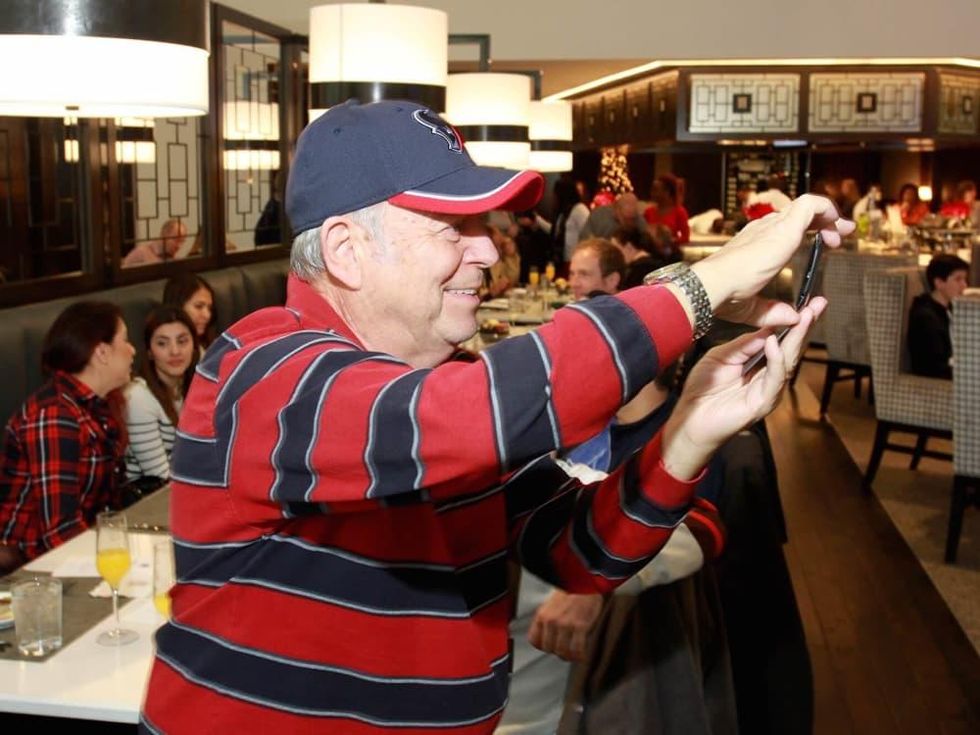 Taste of NFL brunch preview, guest takes photo of chefs in action