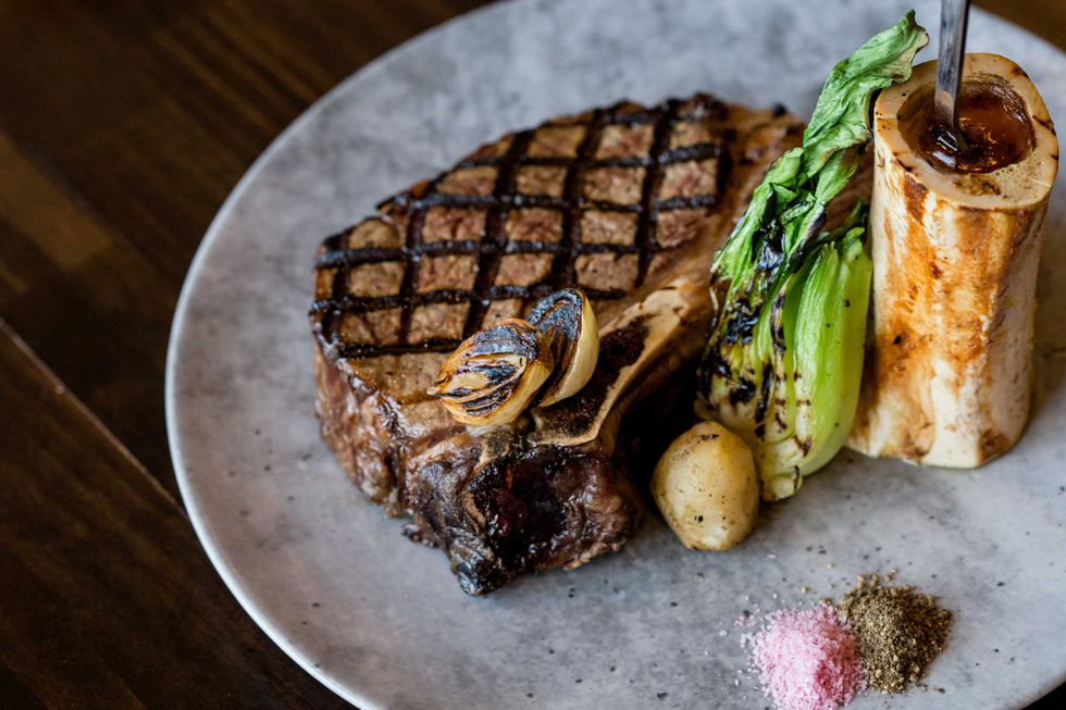 Tenderloin steak on a plate with a bone filled with marrow