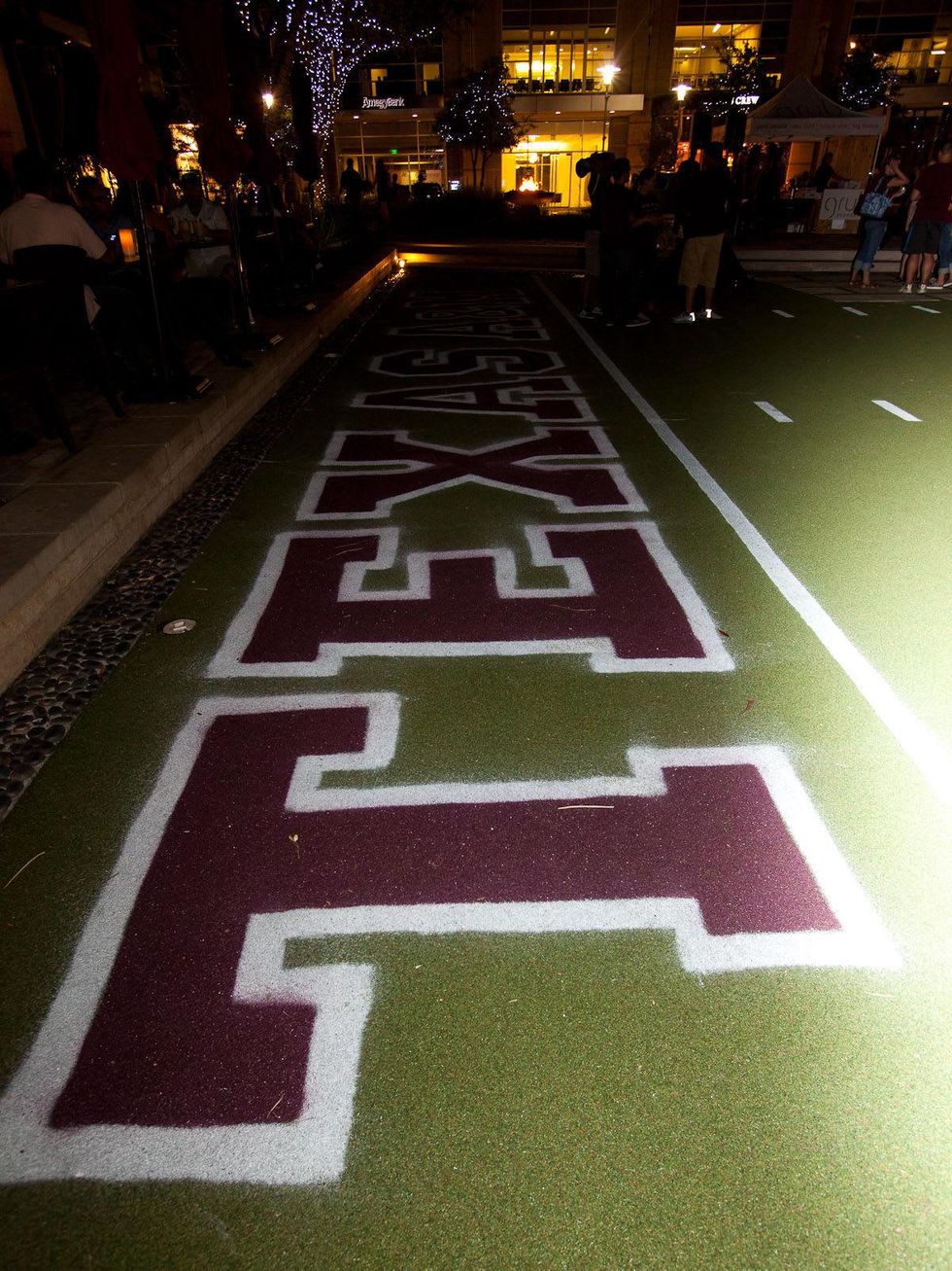 Texas A&M yell practice at CityCentre September 2013 Texas A&M on written on field