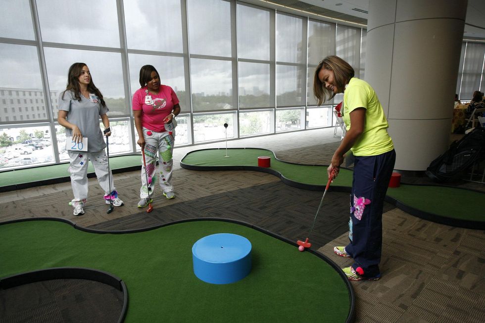 Texas Children's Hospital NICU nurses take a short break from work with a few rounds of putt-putt at the Bad Pants Open kick-off party
