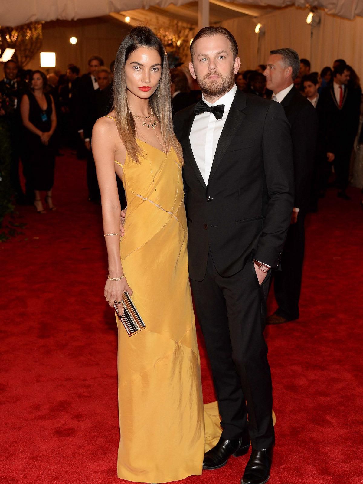 Model Lily Aldridge, in a Tommy Hilfiger mustard silk bias cut slip gown,  and singer guitarist Caleb Followill of Kings of Leon - CultureMap Houston