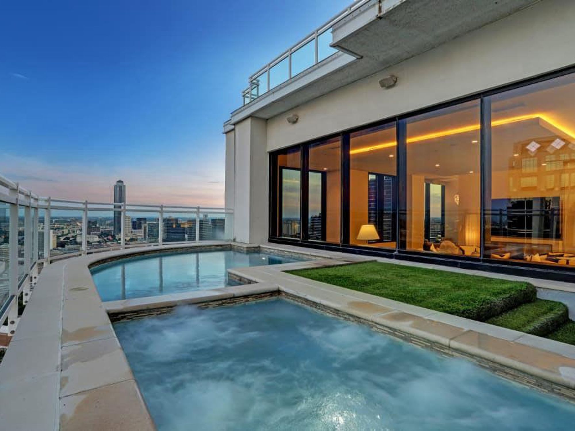 The outdoor space features a pool and sweeping views.