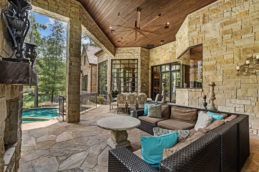The stone paved back patio of 50 Patti Lynn Lane, overlooking the in ground pool