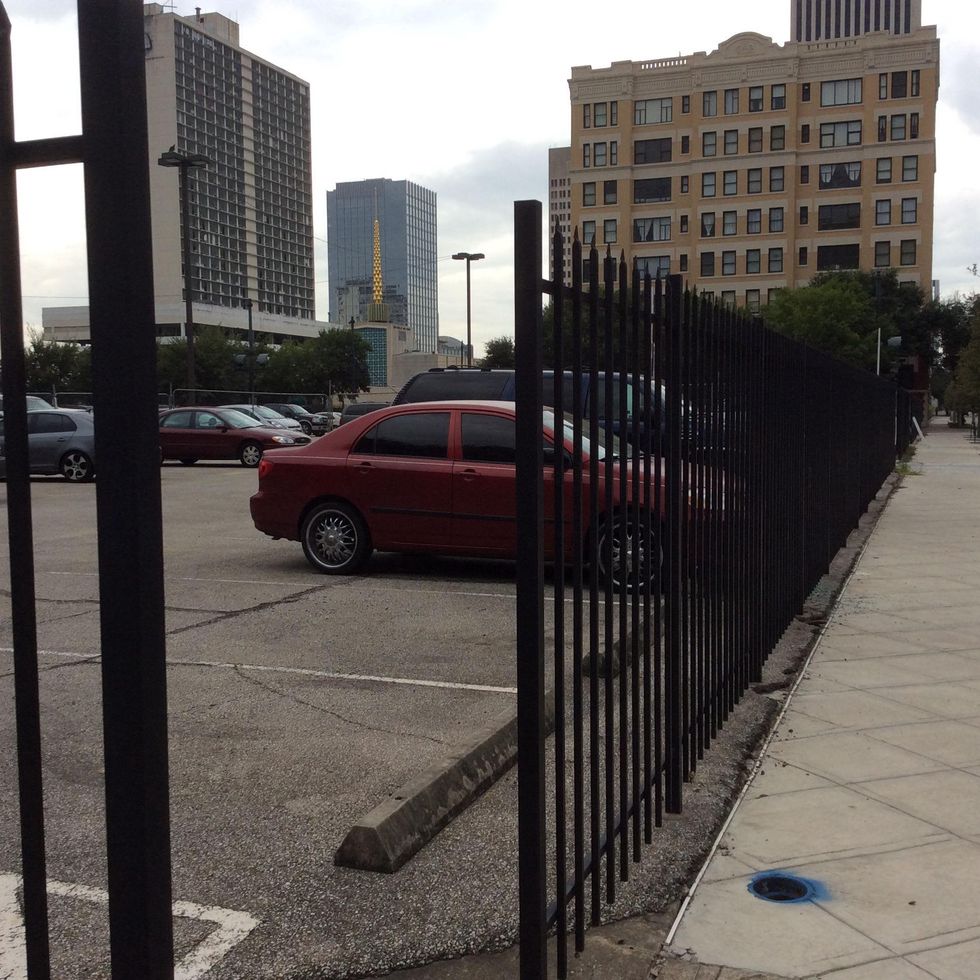 This surface parking lot, bounded by Main, Pease, Fannin and Jefferson, will be the site of SkyHouse Main, a twin to the new apartment tower that opened across the street. September 2014