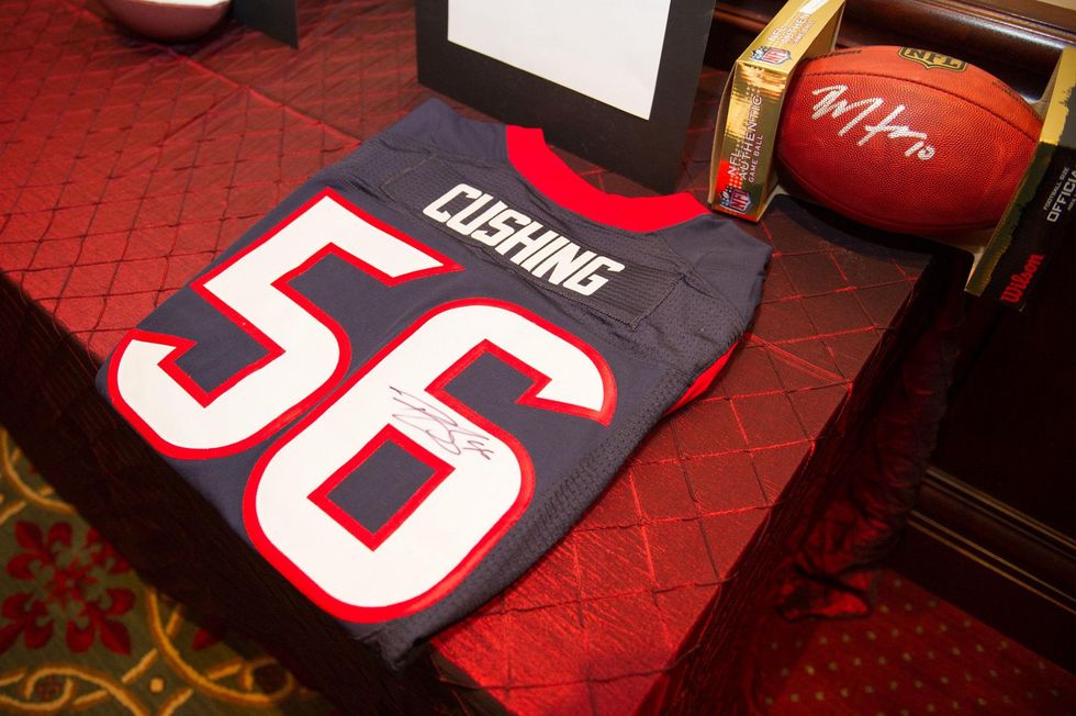 Tom Gros of NRG donated a Brian Cushing autographed Texans jersey in honor of the speaker, Jamey Rootes at the Alley Theatre Wild Things Dinner October 2014