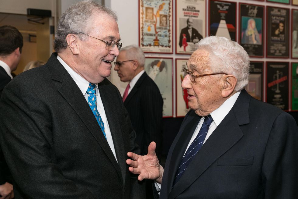 Tom Johnson, left, and Henry Kissinger
