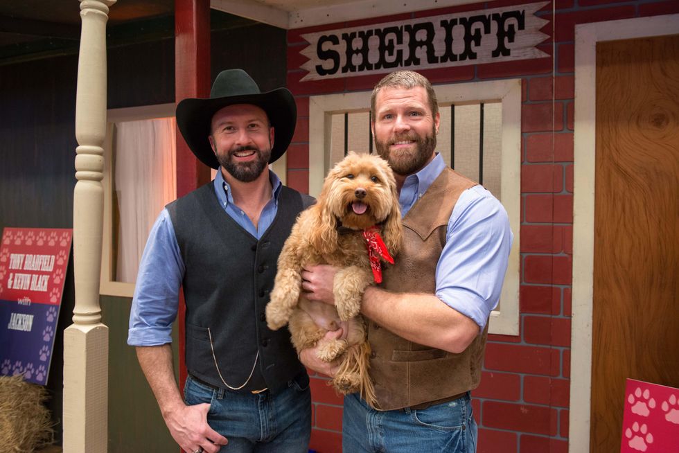 Tony Bradfield, left, and Kevin Black with Jackson at the Citizens for Animal Protection Gala November