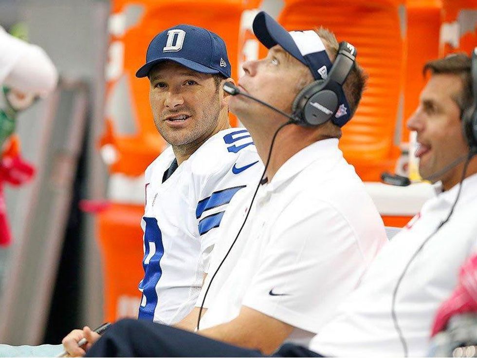 Tony Romo watches from bench