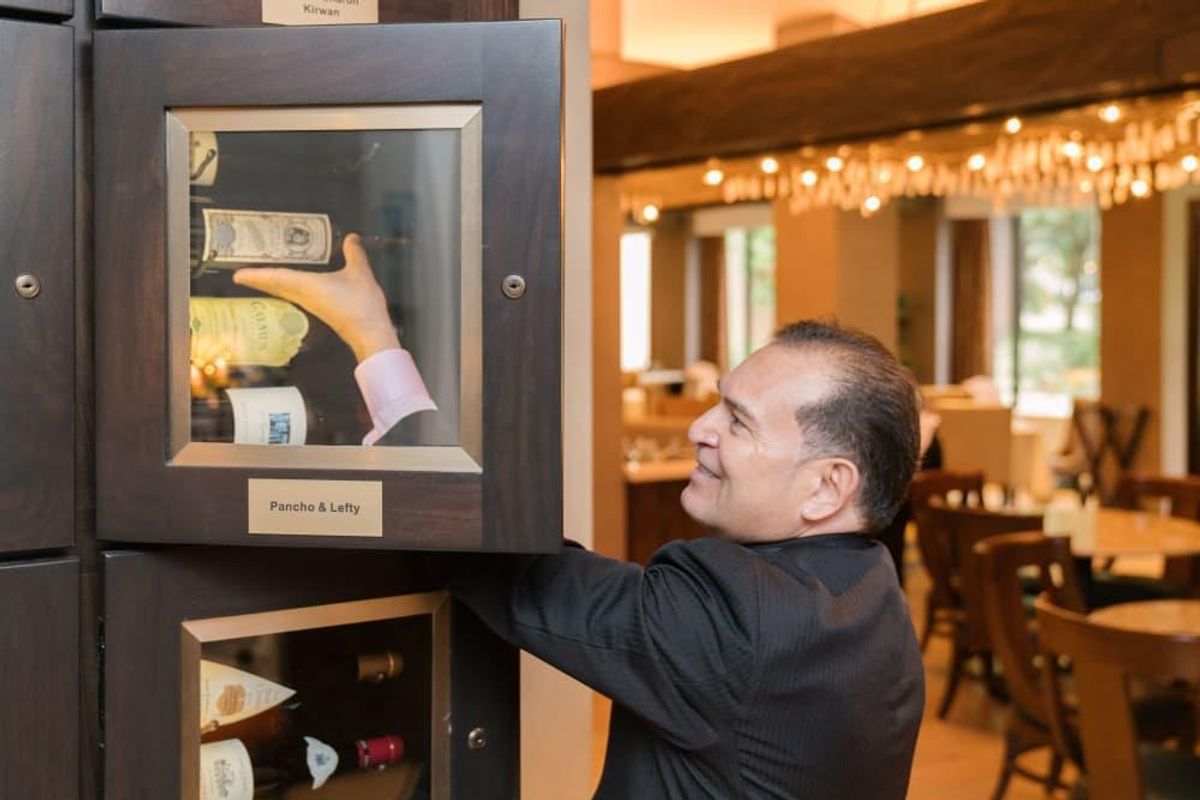 TRIBUTE’s wine story begins with rows of backlit wine lockers tended