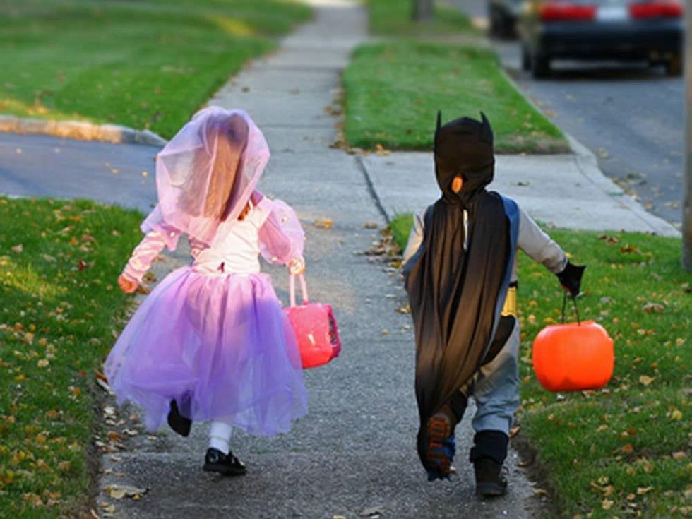 trick or treat children in Halloween costumes