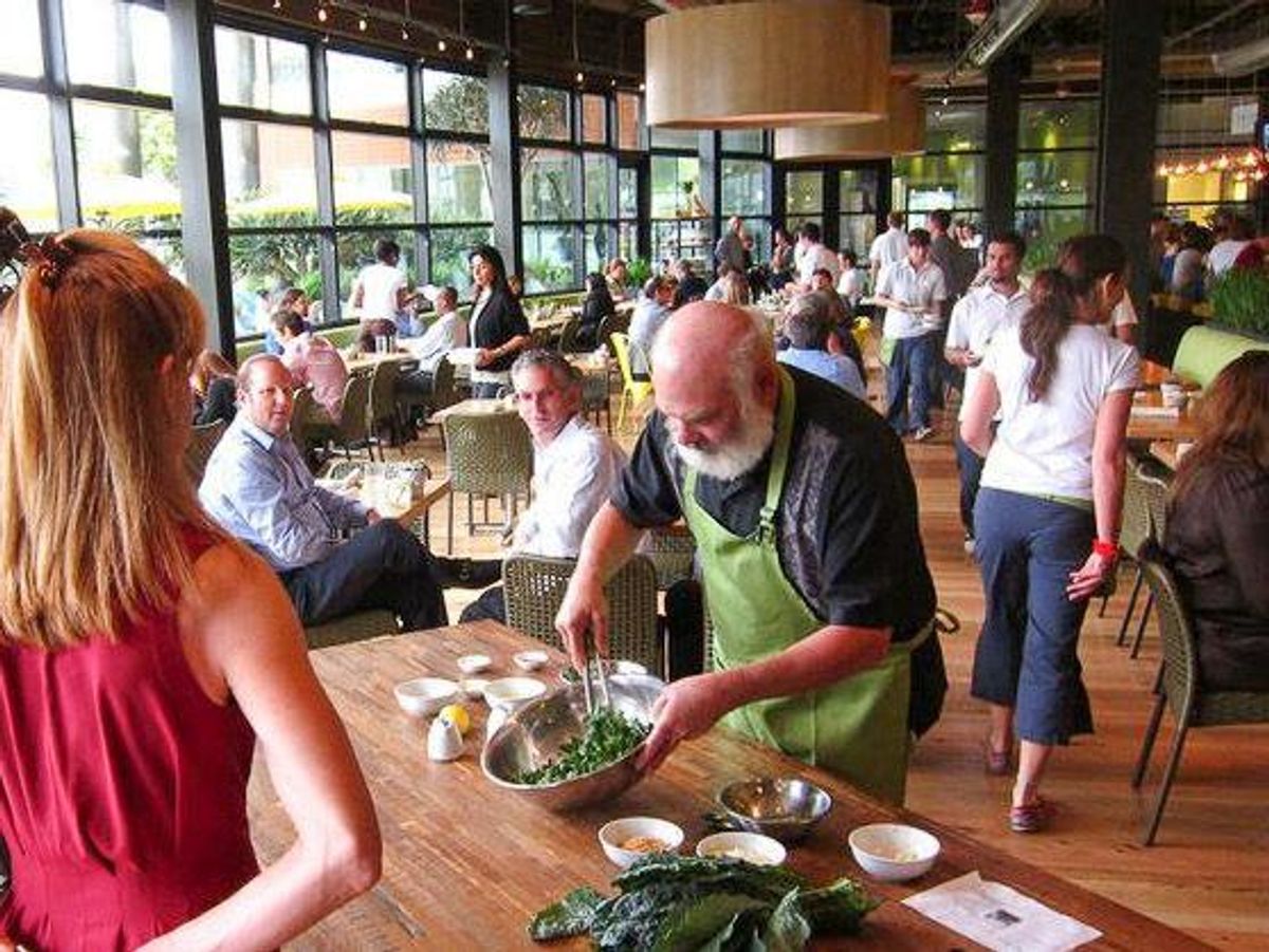 Dr. Andrew Weil prepares a kale salad at the True Food Kitchen location