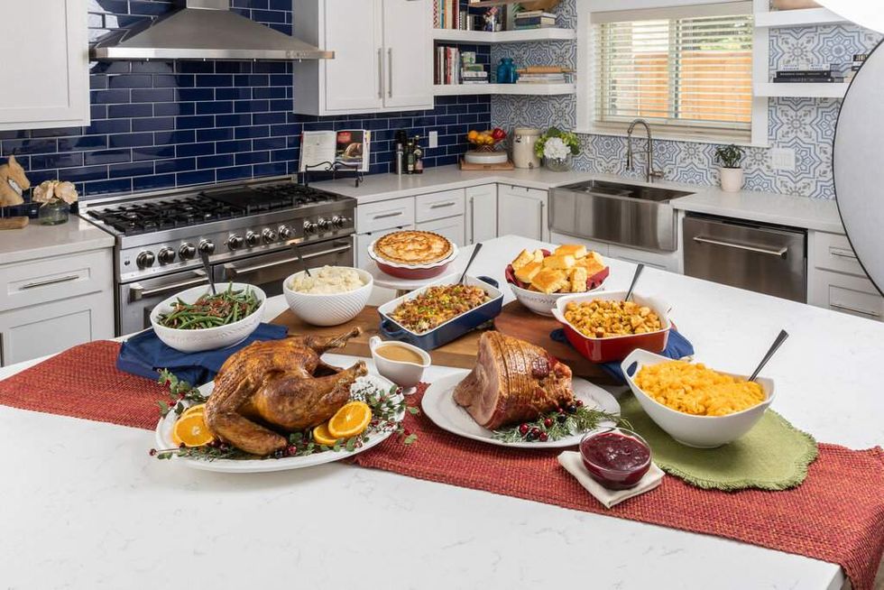 Turkey and ham and side dishes on a kitchen counter