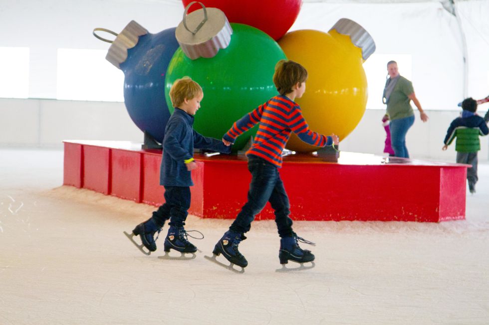 Two little boys ice skating