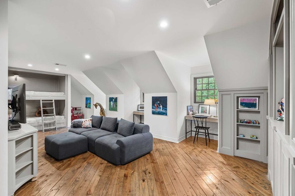 Upstairs open space with slated eaves, built-in bunk beds, and study nooks