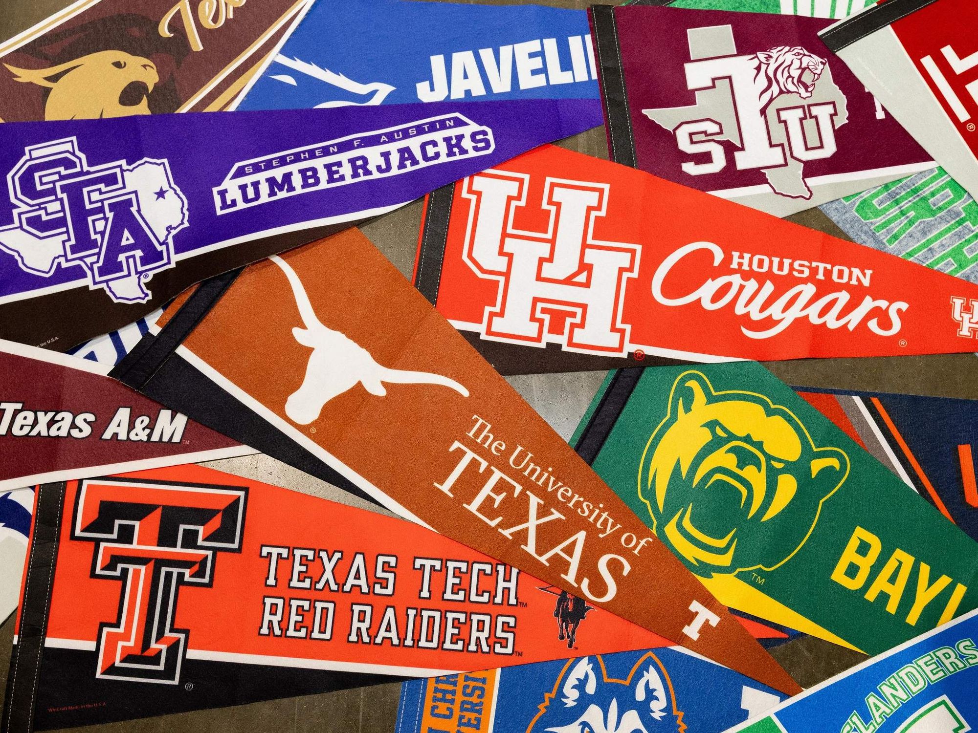 Various pennants from Texas colleges including Texas Tech, University of Texas, Texas A&M, University of Houston, and Baylor.