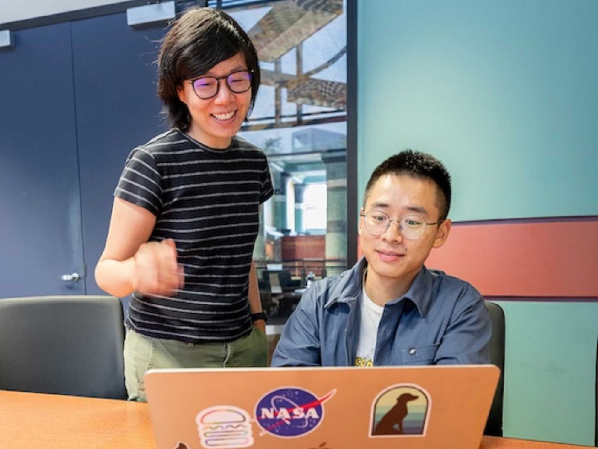 Vicky Yao and Qiliang Lai of Rice University work on a laptop.