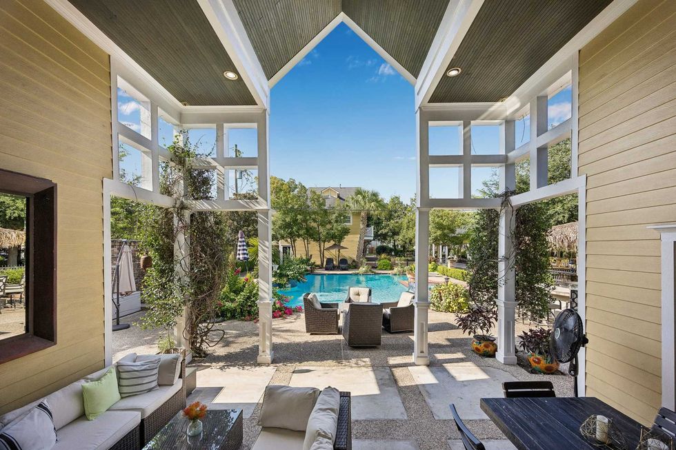 View from the patio of the pool house of 216 E. 26th St. in the Heights, overlooking the pool and ample seating
