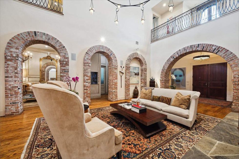 View of living room with three brick archways of 3207 Sackett St.