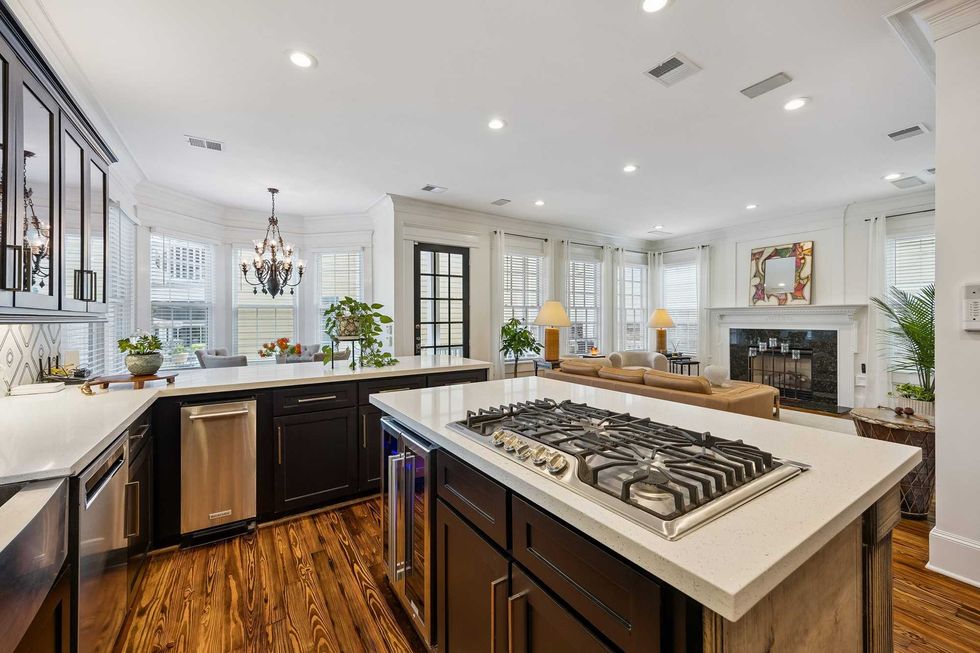 View of the kitchen of 216 E. 26th St. in the Heights showing a kitchen island overlooking the living room