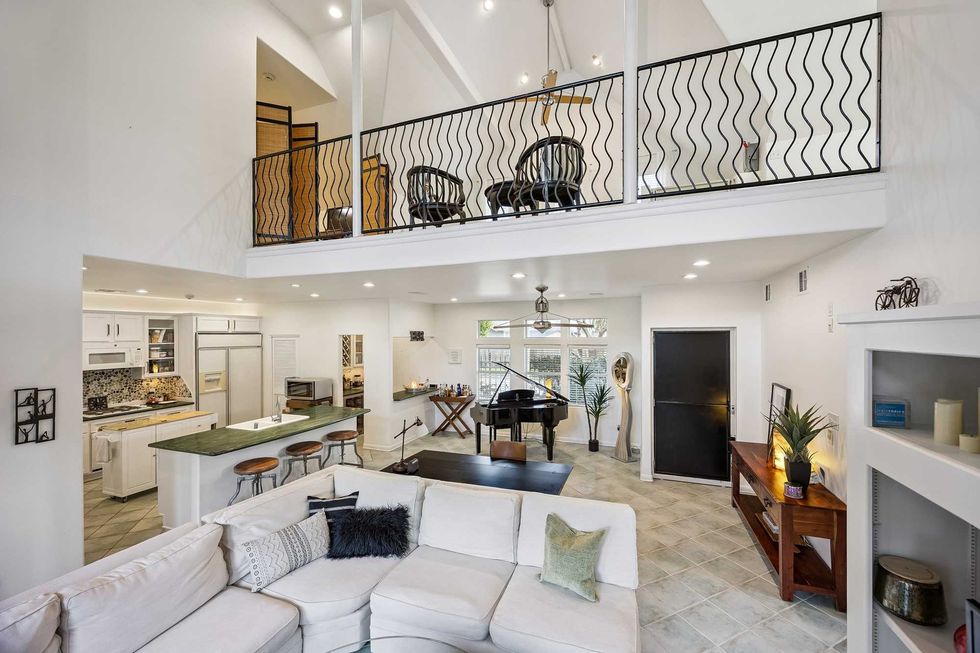 View of the living room, kitchen and upstairs game room of 216 E. 26th St. in the Heights