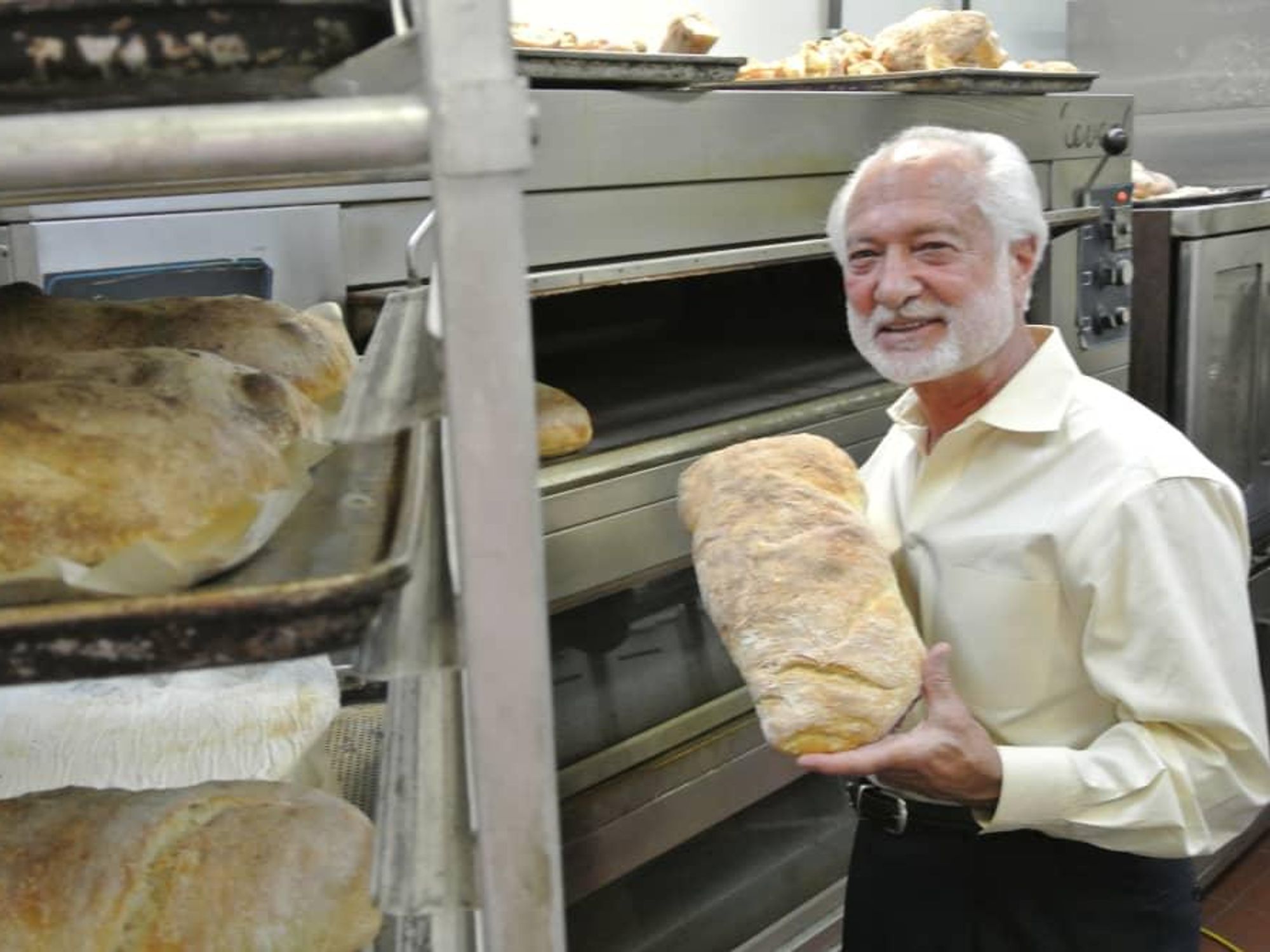 Vincent Mandola of Nino’s and Vincent’s, holding the Grand Prize, the Ciabatta loaf.