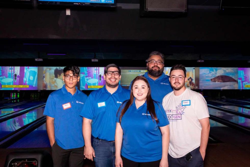 Viridiana Salinas (center), owner at The Viridian Agency (Allstate), Purple sponsors of the event.