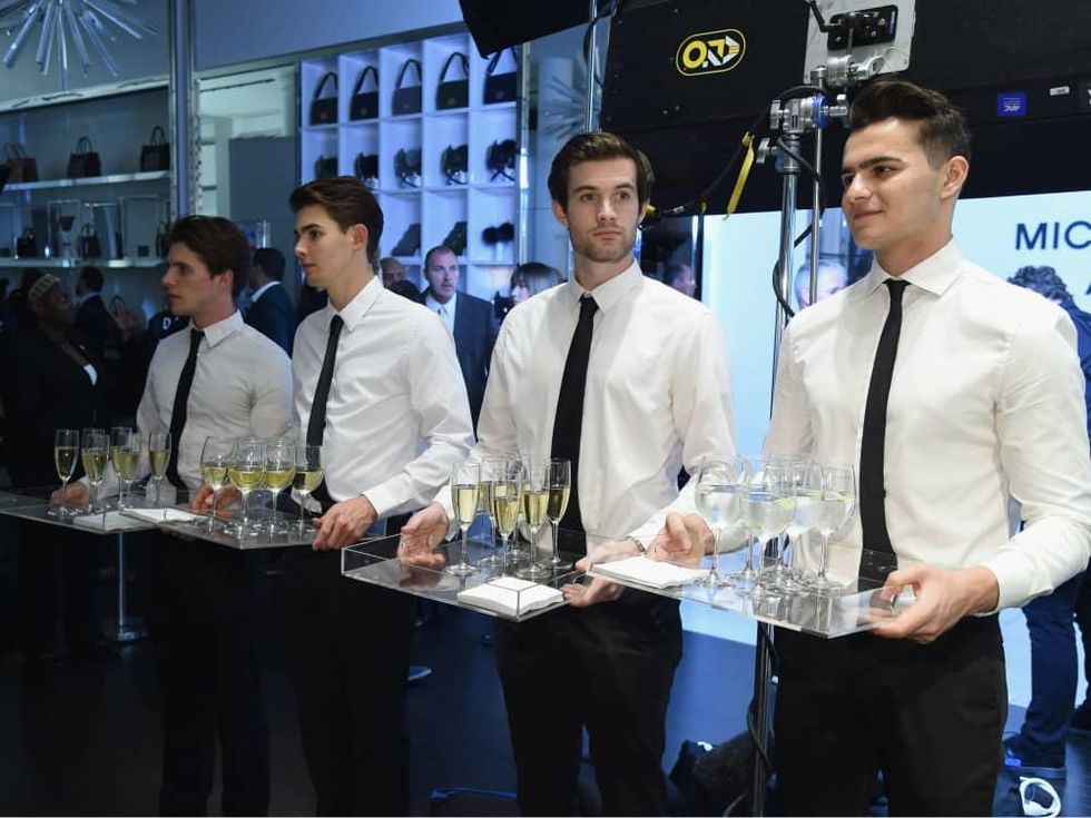 Waiters with champagne at Michael Kors watch launch