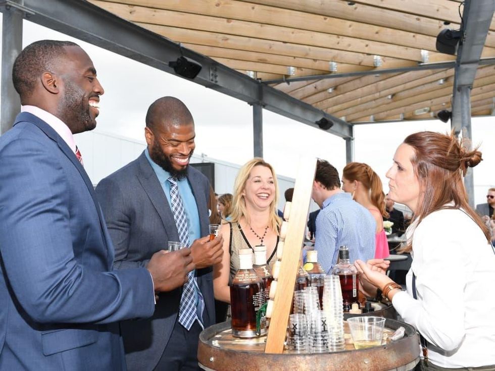 Whitney Mercilus, Wade Smith, Julie Baker Finck during TX Whiskey Sampling at Barbara Bush Foundation gala kickoff
