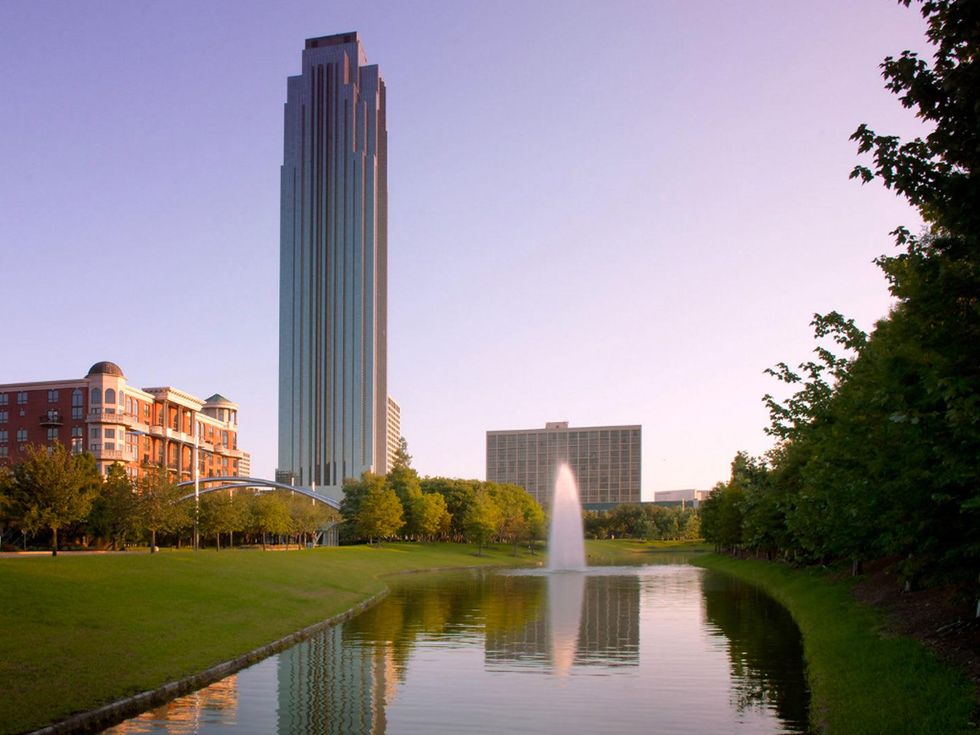 Williams Tower with fountain in bayou in front day