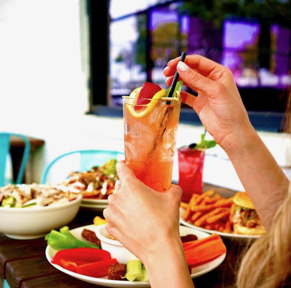 Woman drinking a cocktail on a patio
