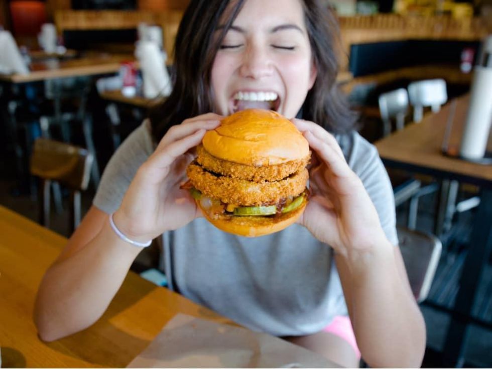 Woman eating the Lockhart Legend burger