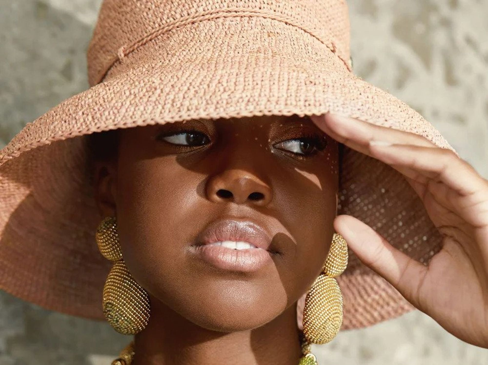 woman in sun hat and beaded jewelry 