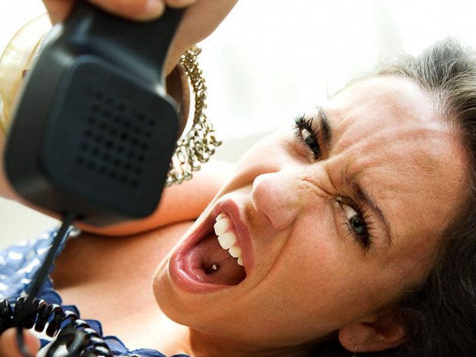 woman mad and swearing while on the phone