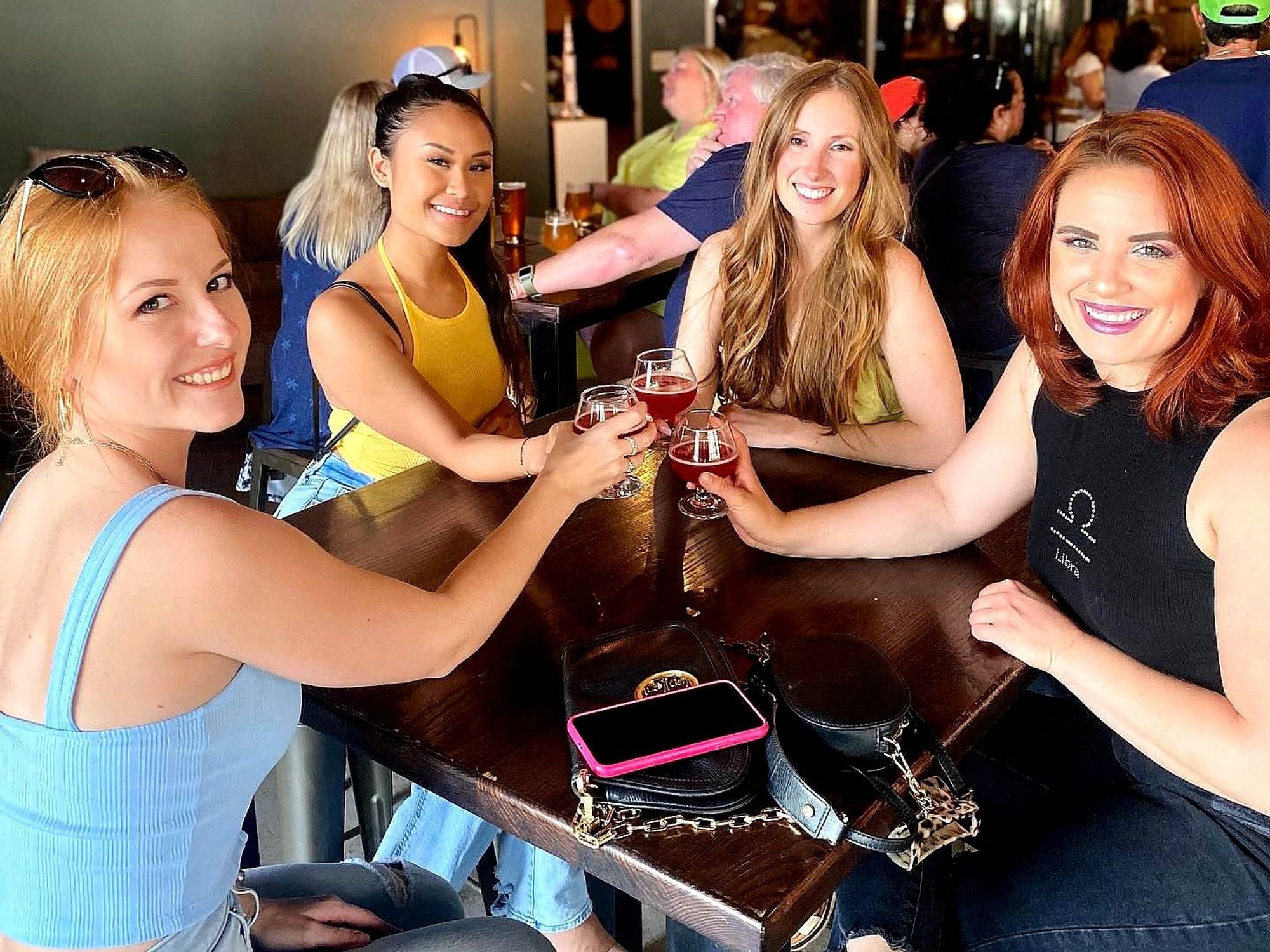 women drinking beer true anomaly houston brewery