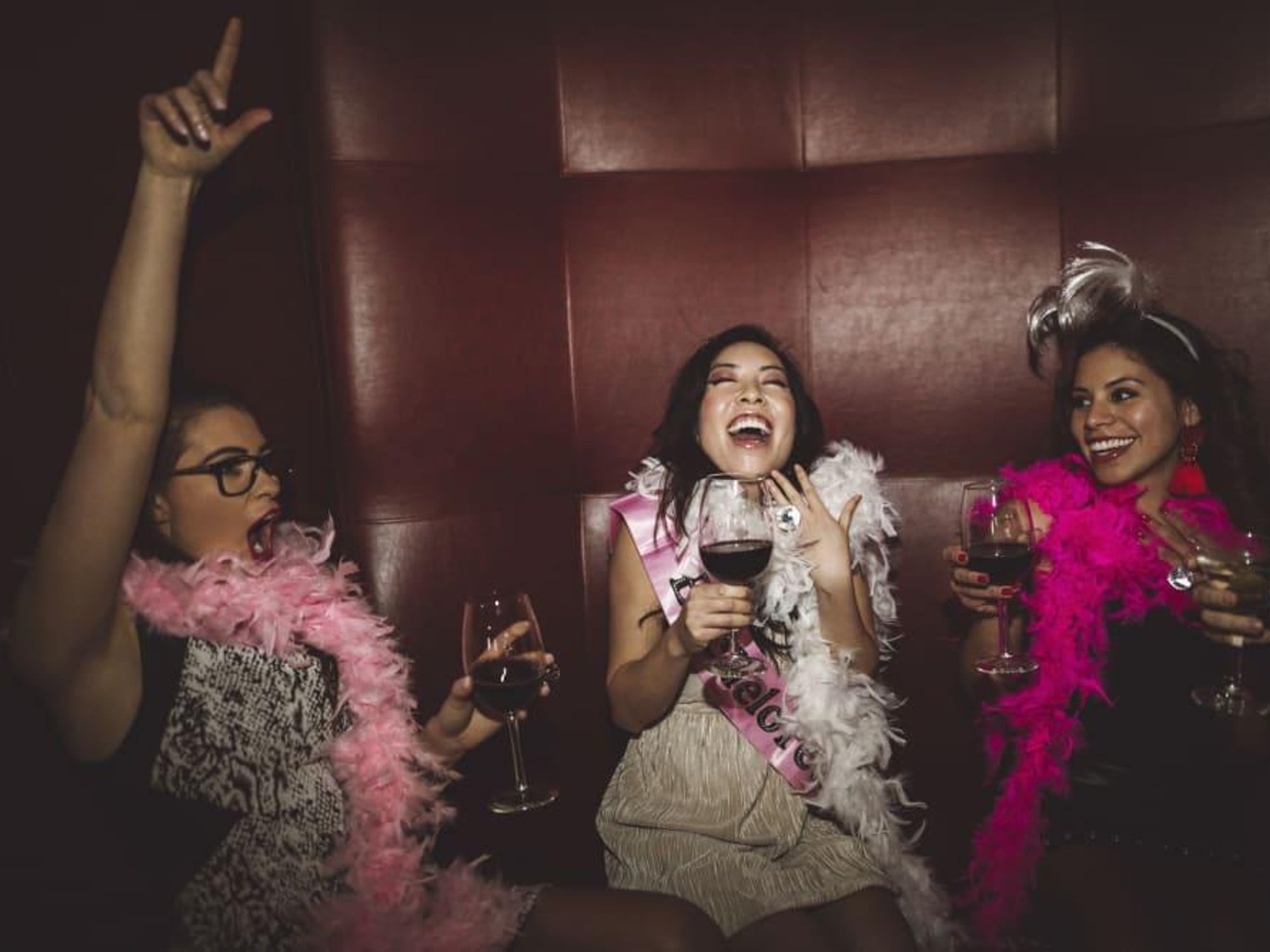 Women laughing drinking wine